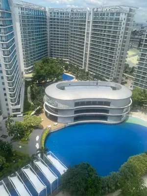 a large building with a large pool in front of tall buildings at azure urban resort residences in Manila