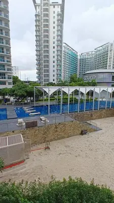 a building with a pool in front of some tall buildings at azure urban resort residences in Manila