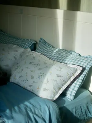 a bed with two pillows on top of it at Whimsy Stay in Manila
