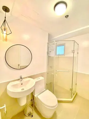 a bathroom with a toilet and a sink and a mirror at Vacation Home by Star in Manila