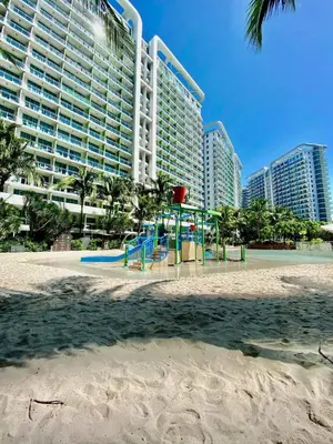 a playground on the beach in front of a hotel at Vacation Home by Star in Manila