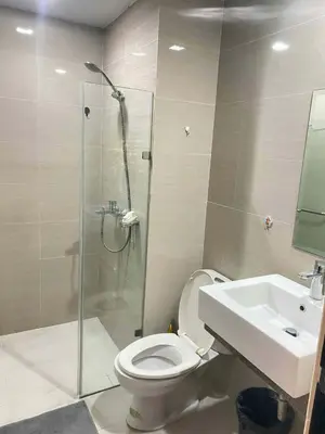 a bathroom with a shower and a toilet and a sink at Cluster 5 9H in Manila