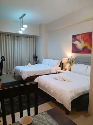 a room with two beds in a room at Cluster 5 9H in Manila