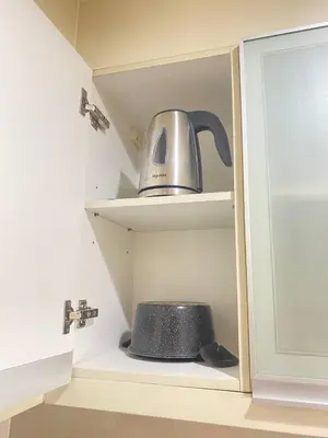 a tea kettle sitting on a shelf in a kitchen at Cluster 5 9H in Manila