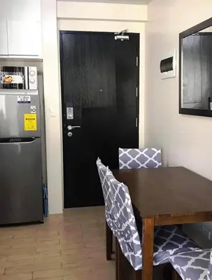 a black door in a kitchen with a table and chairs at A Home Away From Home in Manila