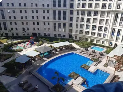 an overhead view of a pool in front of a building at A Home Away From Home in Manila