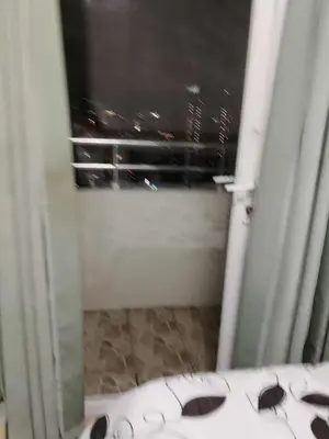 a bathroom with a window with sunglasses on the floor at Birch tower Condominium in Manila