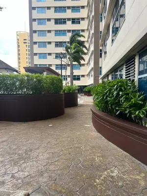 a courtyard in a building with plants and buildings at Robinson's Place Residences, in Manila