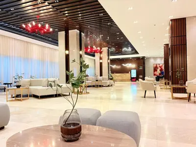 a lobby with a table with a vase on it at Trouvaille in Red Residences in Manila