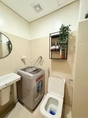 a small bathroom with a toilet and a sink at Trouvaille in Red Residences in Manila