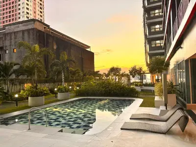 a swimming pool in the middle of a city at Trouvaille in Red Residences in Manila