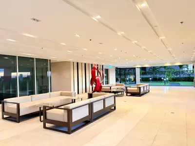 a lobby with couches and a statue of a woman at Trouvaille in Red Residences in Manila