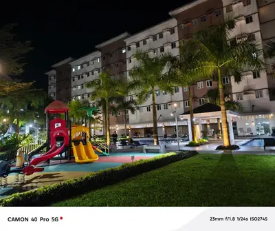a playground in front of a hotel at night at K&C Suite in Trece Martires