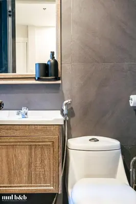 a bathroom with a toilet and a sink at UP TO 6 PAX! Spacious Loft 2 BR near High Street, BGC Fort Victoria The Fort, Taguig City in Manila