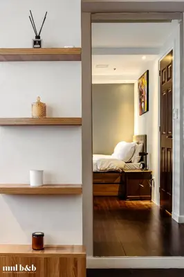 a bedroom with a bed and a mirror at UP TO 6 PAX! Spacious Loft 2 BR near High Street, BGC Fort Victoria The Fort, Taguig City in Manila