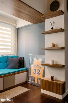 a living room with a blue couch and a window at UP TO 6 PAX! Spacious Loft 2 BR near High Street, BGC Fort Victoria The Fort, Taguig City in Manila