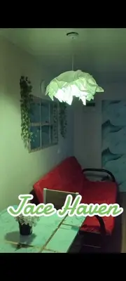 a room with a table with a red bed and a light at Jace Haven 1 Room 2 Beds in Binangonan