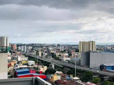 a view of a city with a highway and buildings at Hub Metro in makati 100west 1br with balcony in Manila