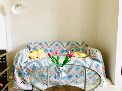 a table with a vase of flowers on a couch at Hub Metro in makati 100west 1br with balcony in Manila