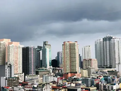 a view of a city with tall buildings at Hub Metro in makati 100west 1br with balcony in Manila