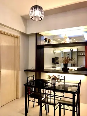 a dining room with a black table and chairs at SMDC Jazz Residence by rhoda kotani in Manila