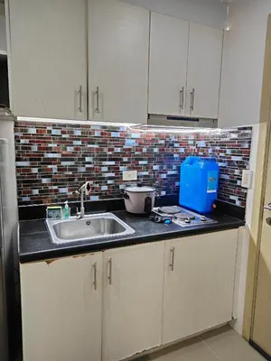 a kitchen with a sink and a counter top at SMDC Jazz Residence by rhoda kotani in Manila
