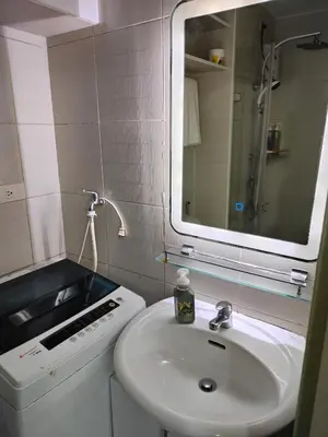 a white bathroom with a sink and a mirror at SMDC Jazz Residence by rhoda kotani in Manila