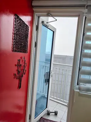 a door with a mirror next to a balcony at SMDC Jazz Residence by rhoda kotani in Manila