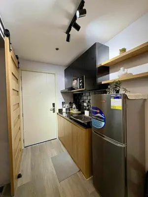 a kitchen with a stainless steel refrigerator and a door at Cozy Sunset Condo Thompson Stay in Manila