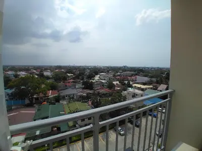 a view of a city from a balcony at Cozy Sunset Condo Thompson Stay in Manila