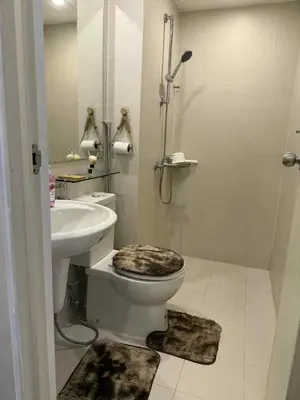 a bathroom with a toilet and a sink and a shower at Azure Urban Resort Residences in Manila