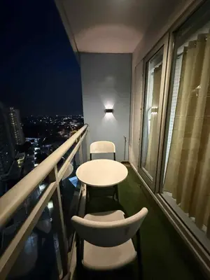 a room with a table and two chairs on a balcony at Azure Urban Resort Residences in Manila