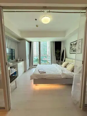 a large bedroom with a bed and a large window at Light residence in Manila