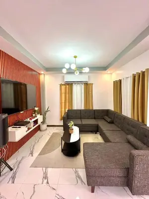 a living room with a couch and a television at Light residence in Manila