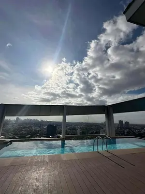 a swimming pool on the top of a building at Light residence in Manila