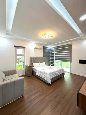 a large bedroom with a bed and a couch at Light residence in Manila