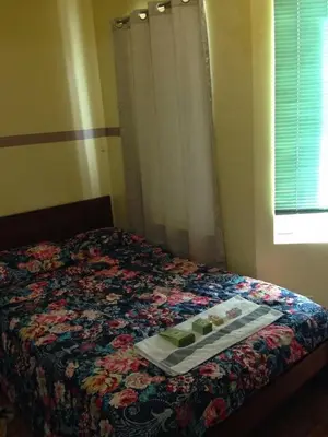 a bed with a tray of food on it at Studio Condominium near the US Embassy in Manila in Manila