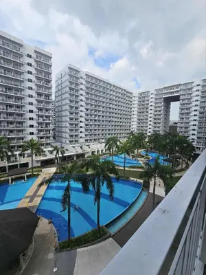 a large apartment complex with a large swimming pool at Shell Residences Mall of asia Pham in Manila