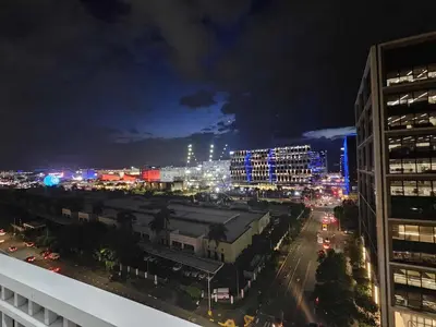 a view of a city at night with lights at Shell Residences Mall of asia Pham in Manila