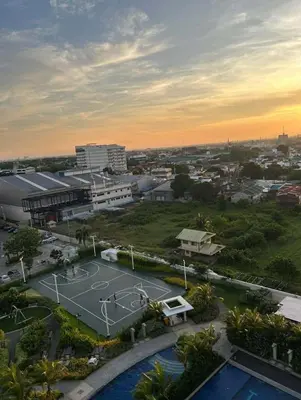 a basketball court in front of a city at One br cozy resort style condo sunset view balcony Robinson Las Pinas in Manila