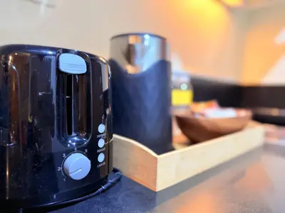 a black toaster sitting on top of a counter at Comfy Stays in Shell Residences by OneGuestPlace in Manila