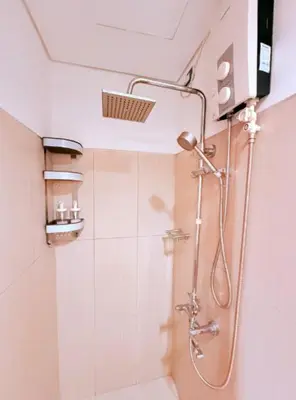 a bathroom with a shower with a shower head at Comfy Stays in Shell Residences by OneGuestPlace in Manila