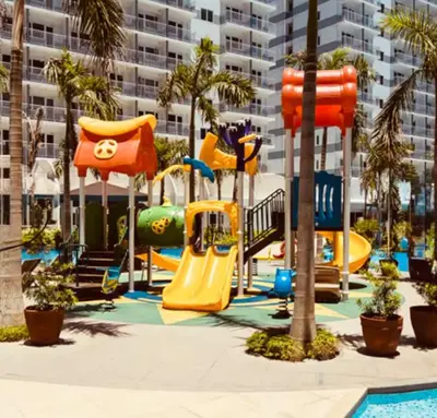 a playground with a slide and a slide at Comfy Stays in Shell Residences by OneGuestPlace in Manila