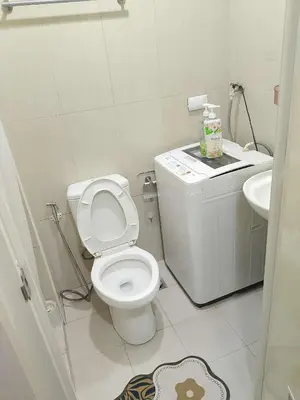 a white bathroom with a toilet and a sink at 1648 b 3beds big cut moa view in Manila