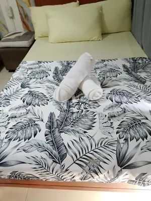 a stuffed animal laying on top of a bed at 1648 b 3beds big cut moa view in Manila
