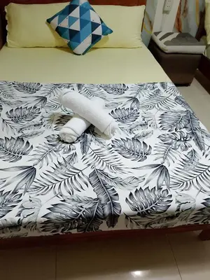 a bed with a black and white comforter on it at 1648 b 3beds big cut moa view in Manila
