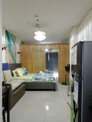 a room with a bed and a couch and a tv at 1648 b 3beds big cut moa view in Manila
