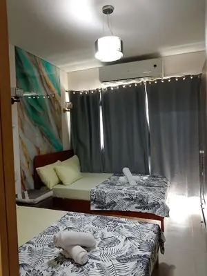 a room with two beds and a couch at 1648 b 3beds big cut moa view in Manila