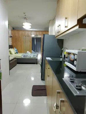 a kitchen and living room with a bed in the background at 1648 b 3beds big cut moa view in Manila