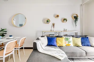 a living room with a couch and a table at Cozy Garden View near Airport WFH Netflix Stay in Manila